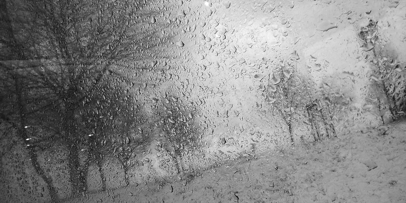 Real photograph of rain gathering on a window